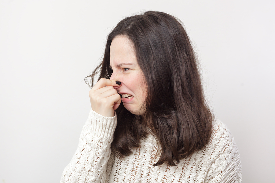 Woman holding her nose